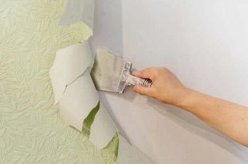 Wallpaper removal in progress in Agoura Hills CA — scraping with putty knife